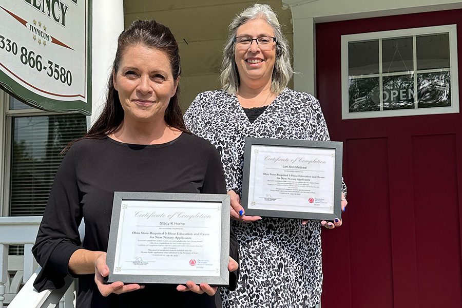 About Our Agency - Finnicum Hometown Insurance Agency Team Members Holding Up Certificates in Front of Their Office